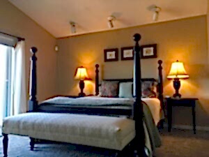 bedroom with four poster bed and slanted ceiling