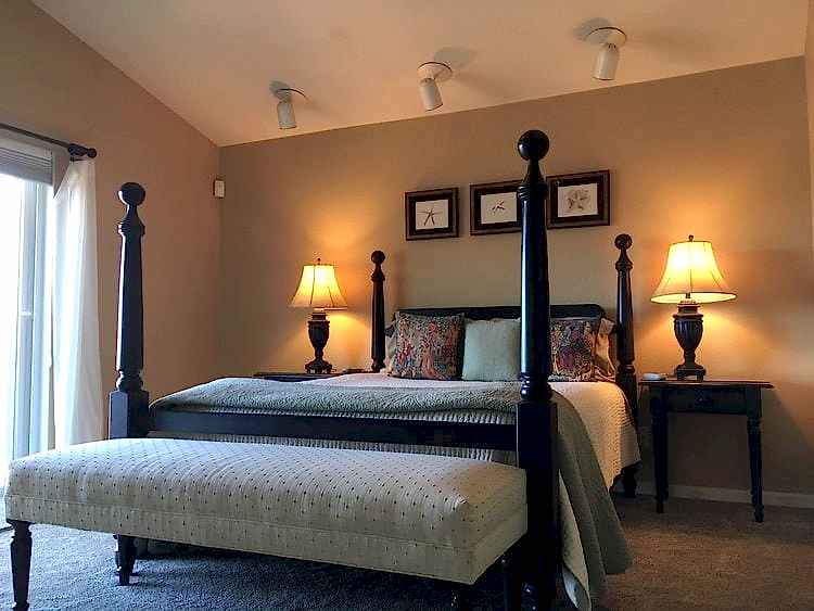 bedroom with four poster bed and slanted ceiling
