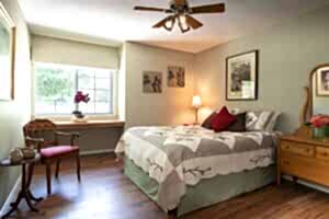sage room with queen bed