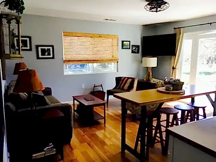 living room across from kitchen with television and couch
