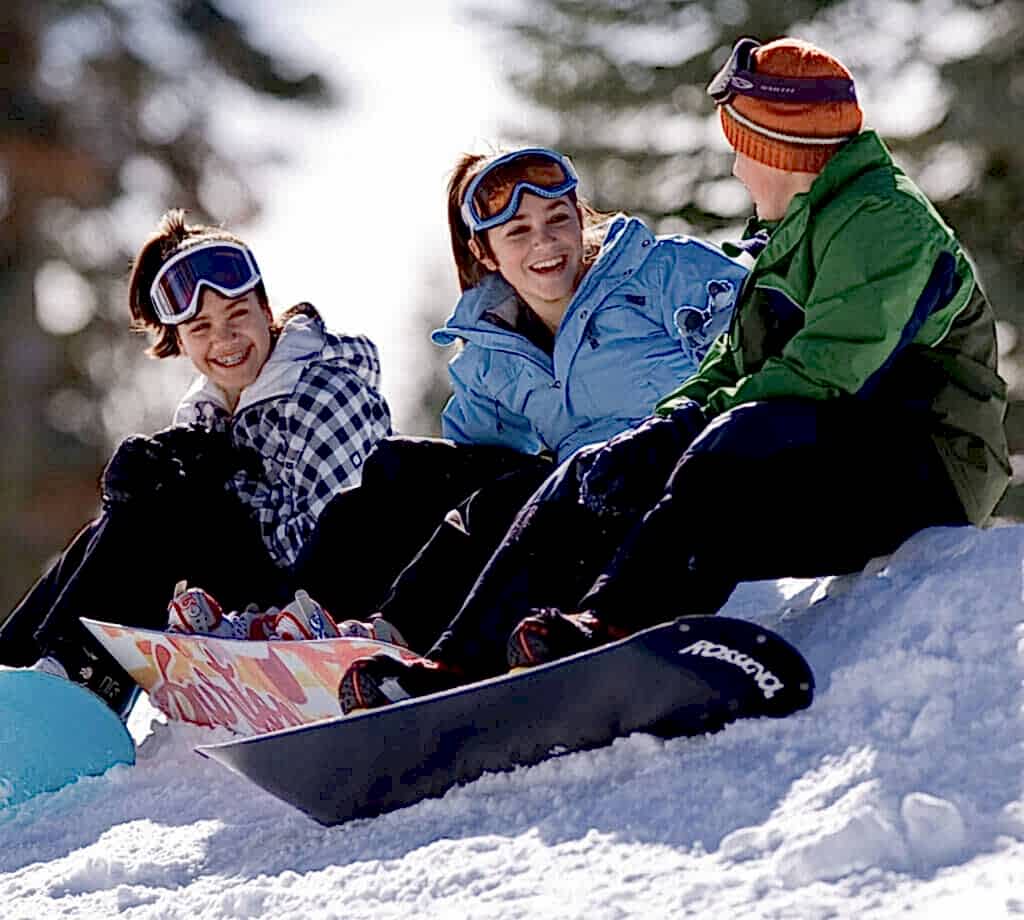 3 snowboarders chatting at Badger Pass in Yosemite